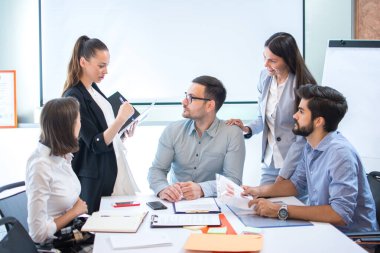 Toplantı masasındaki iş adamları iş ve planlama stratejilerini tartışıyor.