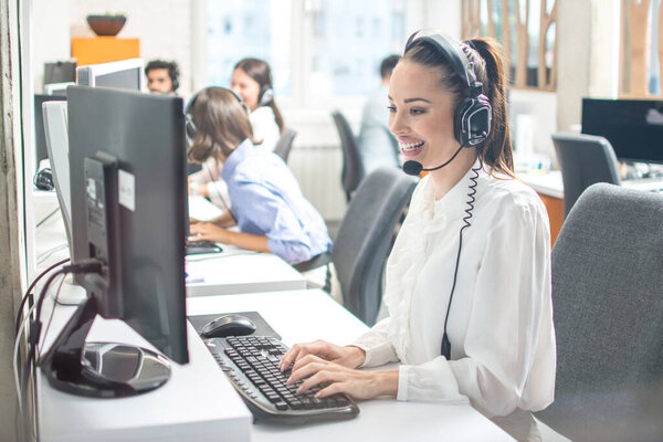 Female call center worker accompanied by her team