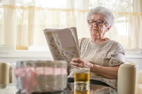 Senior Mulher Relaxante Com Palavras Cruzadas Puzzle Casa — Fotografia de Stock