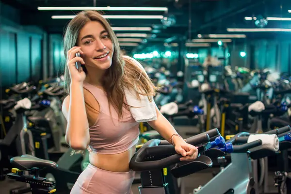 Smiling Young Woman Using Phone Cycling Training Spin Studio — Stock Photo, Image