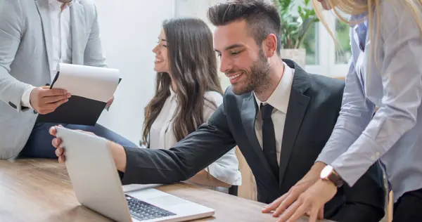 stock image Handsome young businessman in formal-wear suit on a meeting with business partners in office