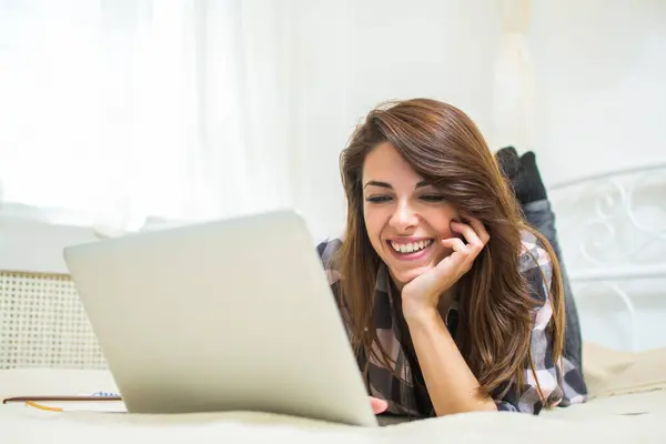 Sorridente Giovane Donna Utilizzando Computer Portatile Mentre Sdraiato Sul Letto — Foto Stock