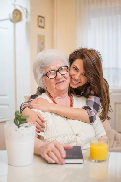 Beautiful Cheerful Teenage Girl Hugging Her Old Grandmother — Stock Photo, Image