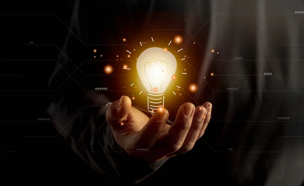 hand holding light bulb. idea concept with innovation and inspiration. Bulb light drawing idea in hand