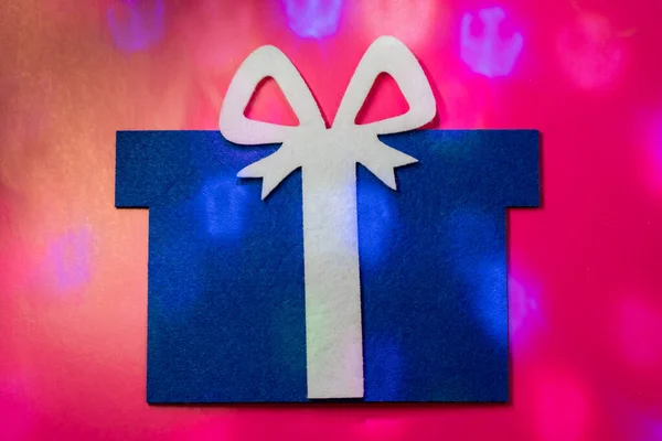 blue felt gift with light colored glare. Flat lay