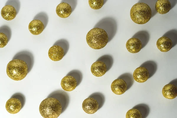 shiny gold balls on a white background.Flat lay