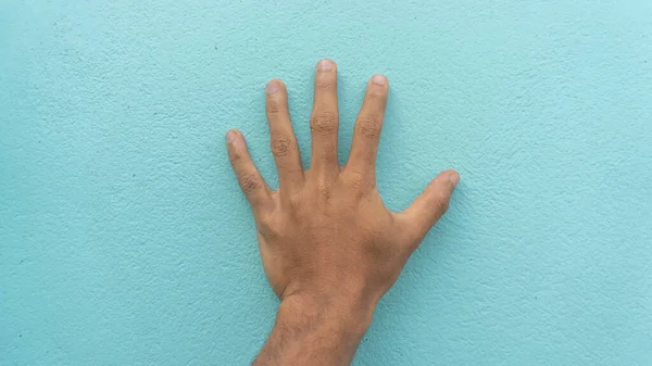 hand on the wall. person touch the wall.