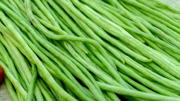 Fresh vegetable in the street market. Healthy green long beans in the market.