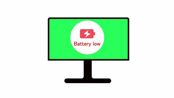 Computer monitor displaying a battery low icon on a green screen background.
