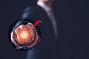 businessman clenched fist punching to target icon in concept of fight for the goal. reaching for goal, 