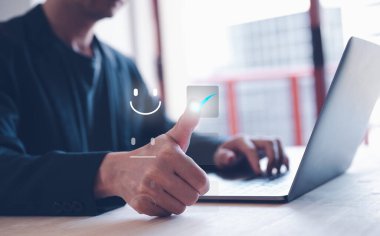 feedback and Customer service satisfaction survey concept.Business people or customers show satisfaction by pressing face emoticon smile in satisfaction on virtual touch screen.	