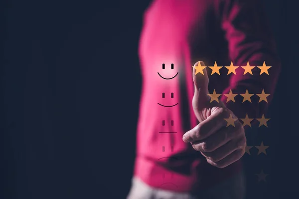 survey feedback Customer service satisfaction survey concept. man shows satisfaction by pressing face emoticon smile and five stars in satisfaction on virtual touch screen. happy emotion
