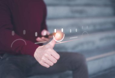 Customer service satisfaction survey concept.Business people or customers show satisfaction by thumb up on face emoticon smile in satisfaction on virtual touch screen.	