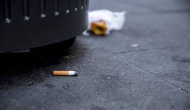 cigarette butt on metal bin