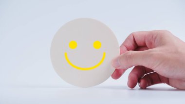 Müşteri hizmetleri değerlendirmesi ve memnuniyet araştırması konseptleri. Müşterinin eli gülen yüz simgesini seçti.