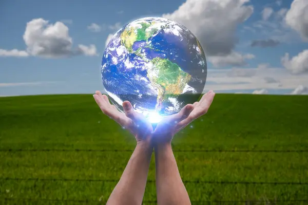 hands holding earth in concept of Happy Earth Day caring for nature, environmental problems and environmental protection, Elements of this image furnished by NASA