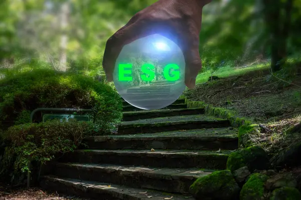 hand holding crystal ball ESG concept. Environment society and governance sustainable business on blurred steps garden autumn background multi exposure