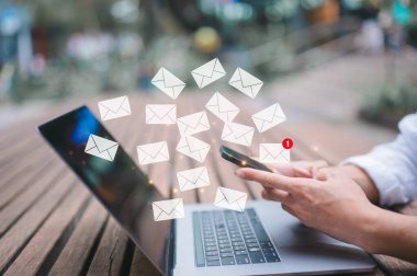 businessman sitting outdoor using computer laptop typing or writing email in concept of online marketing and email concept clipart