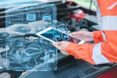 Araba servisi ve kontrol konsepti. Bakım listesi aracı için tableti tutan bir tamircinin eli, Müşteri hizmetleri konsepti araba teknisyeni SOH 'un akü durumunu kontrol ediyor