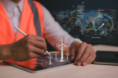 Karbondioksit salınımını ve karbon ayak izini azaltmak için sanal rüzgar türbini diyagramı üzerinde çalışan bir mühendis ya da adam, küresel ısınma iklim değişikliği. Sürdürülebilir kalkınma ve yeşil enerji