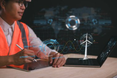 Küresel ısınma ve iklim değişikliğini sınırlamak için karbondioksit salınımını ve karbon ayak izini azaltın. Sürdürülebilir gelişim ve yeşil iş, sürdürülebilir enerji rüzgar türbini diyagramı ile çalışan mühendis