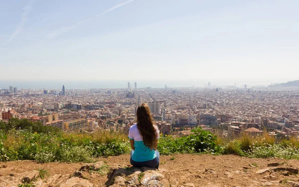 Woman Sitting Rock Facing Away Looking City Barcelona Sunny Day — Stockfoto