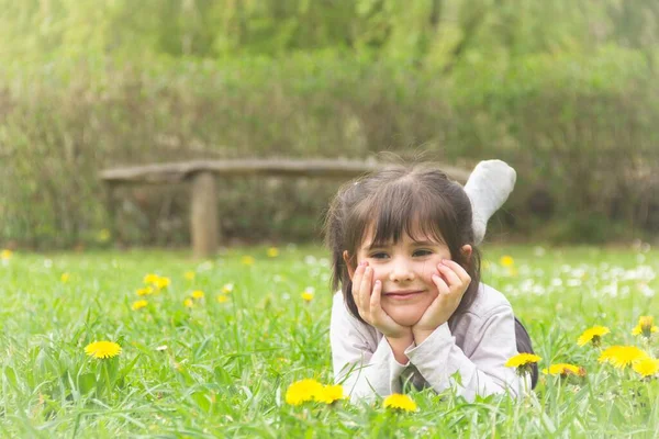 Cute Little Girl Dreamy Look Her Eyes Lying Grass Her — Stok fotoğraf