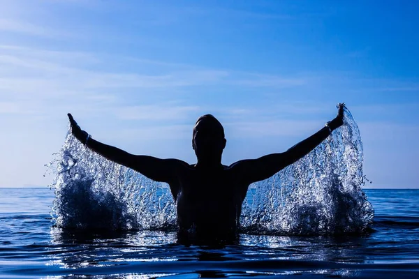 Freeze Motion Silhouette Young Man Splashing Water Open Arms Water — Foto Stock