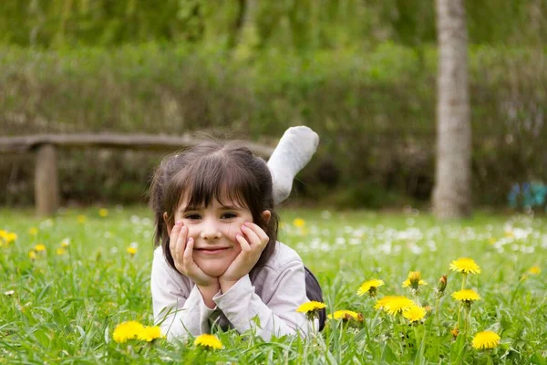 Happy Little Girl Lying Grass Hands Holding Her Face Feet — Foto Stock