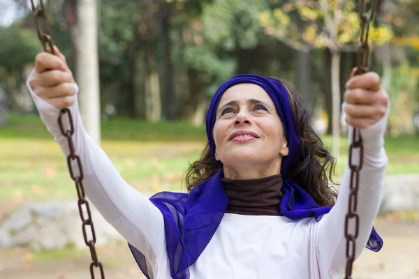 Modern Good Looking Mature Woman Holding Chains While Swinging Playground — Stock Photo, Image