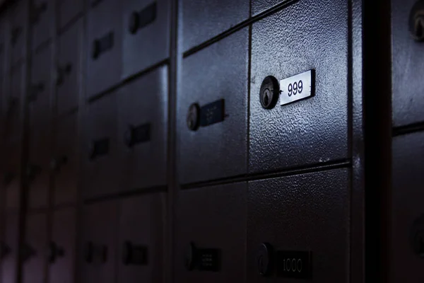 Safety deposit box with nine hundred ninety nine number highlighted in post office. Locker, security concept