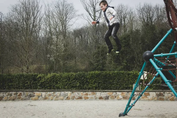Young Kid Jumping Geometric Dome Structure Empty Playground Bilbao Boy Imágenes de stock libres de derechos