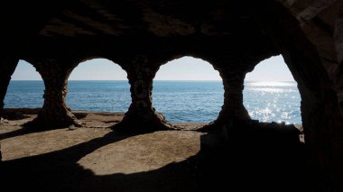 arch of an abandoned stone, on a sunny day in Calpe, Alicante