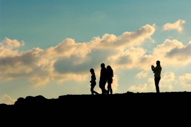 silhouette of father and son on the sunset. concept of family and happiness