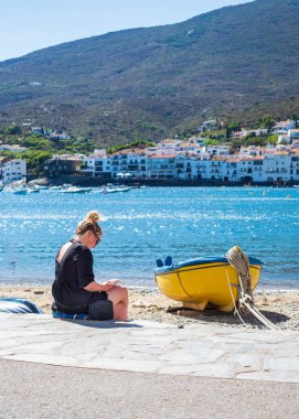 Young girl enjoying the scenery of Cadaques on a sunny day.