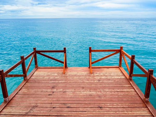 stock image wooden pier on the beach with sea water