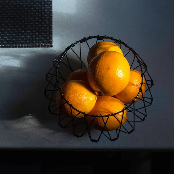 oranges  in the metal basket
