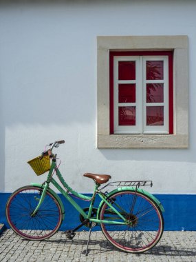 Caddede mavi ve kırmızı eski bir bisiklet