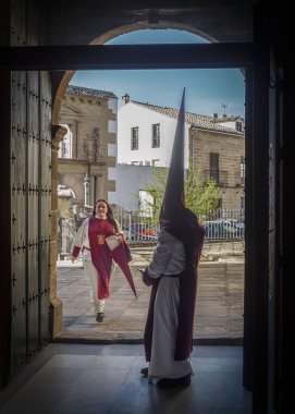 Büyük şapkalı bir adam ve kırmızı elbiseli bir kadın.