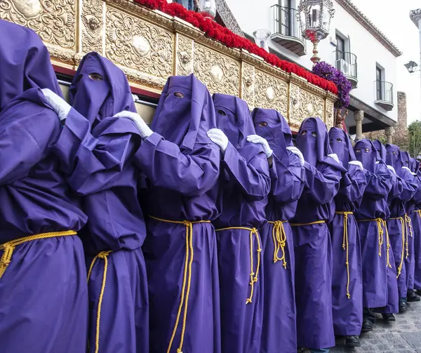 stock image a group of people in purple robes standing in front of a building