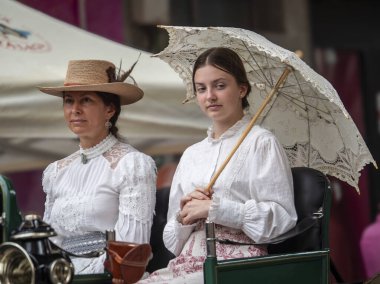 Fuengirola, İspanya. 09/23/2024. İnsanlar tipik Endülüs kostümleri giyip Fuengirola 'daki At Günü kutlamalarında klasik bir arabaya biniyorlardı..