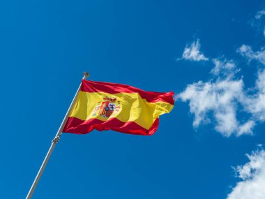 Mavi gökyüzünün arka planında İspanya bayrağı