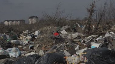 Konut alanlarının yakınında büyük miktarlarda ev atığı birikmiş. Ev atıklarının kullanımı. Çevre kirliliği. Ekolojik felaket.