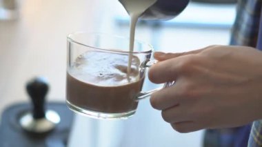 Unrecognizable barista preparing cup of coffee in coffee machine, close up. Process of making hot coffee in coffee shop.