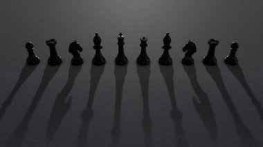 Dramatik ışık saçan ve etkileyici gölgeler yaratan siyah satranç taşları.