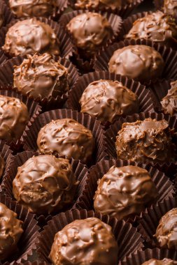 Gift chocolates in boxes of different colors, shapes and patterns on a white background