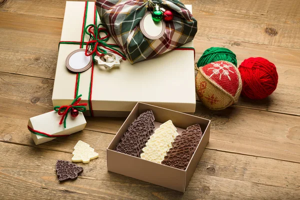 Gift chocolates in boxes of different colors, shapes and patterns on a white background