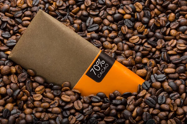 A chocolate package inside coffee beans
