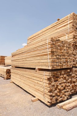 Stacks of lumber stacked and tied in warehouse
