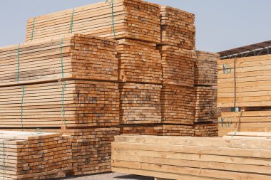 Stacks of lumber stacked and tied in warehouse